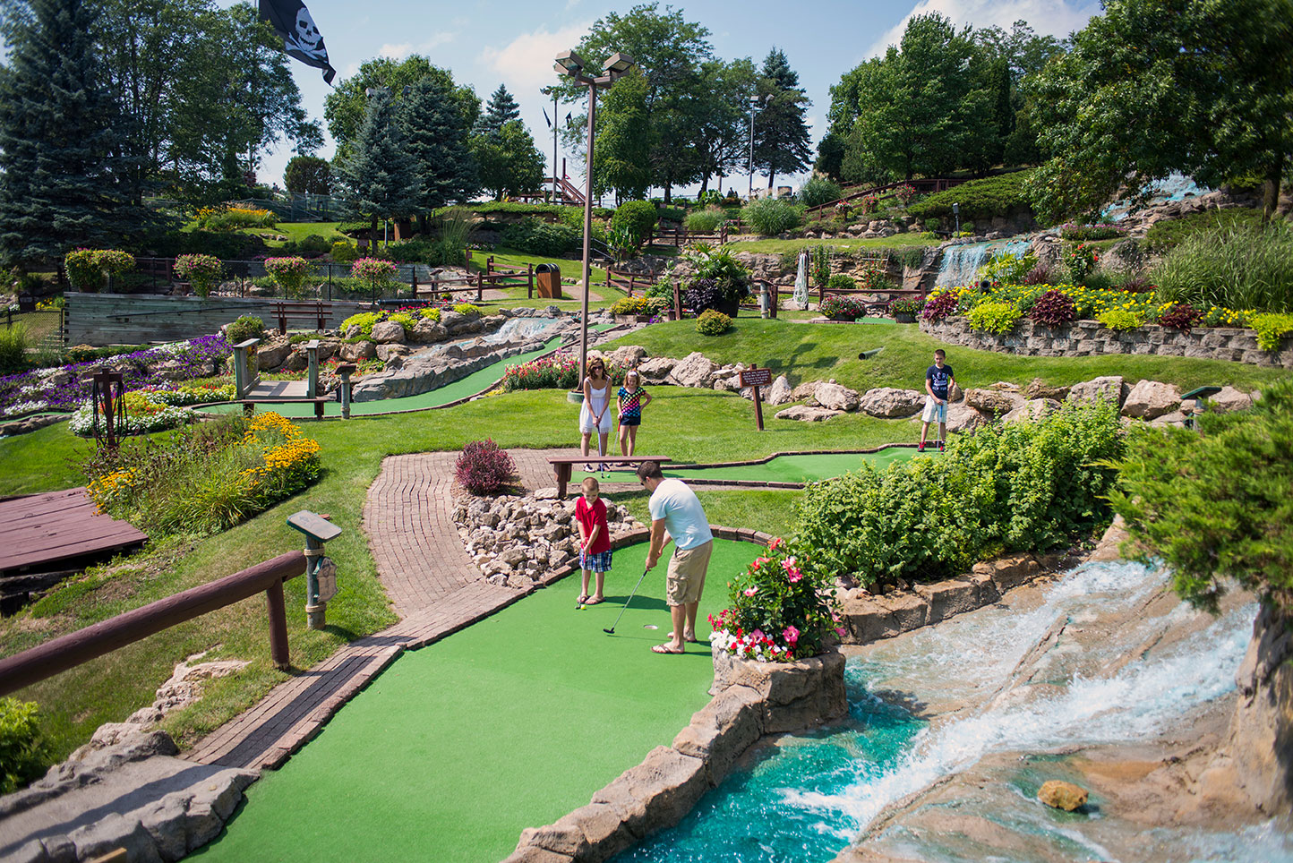 people playing mini golf in a miniature golf course
