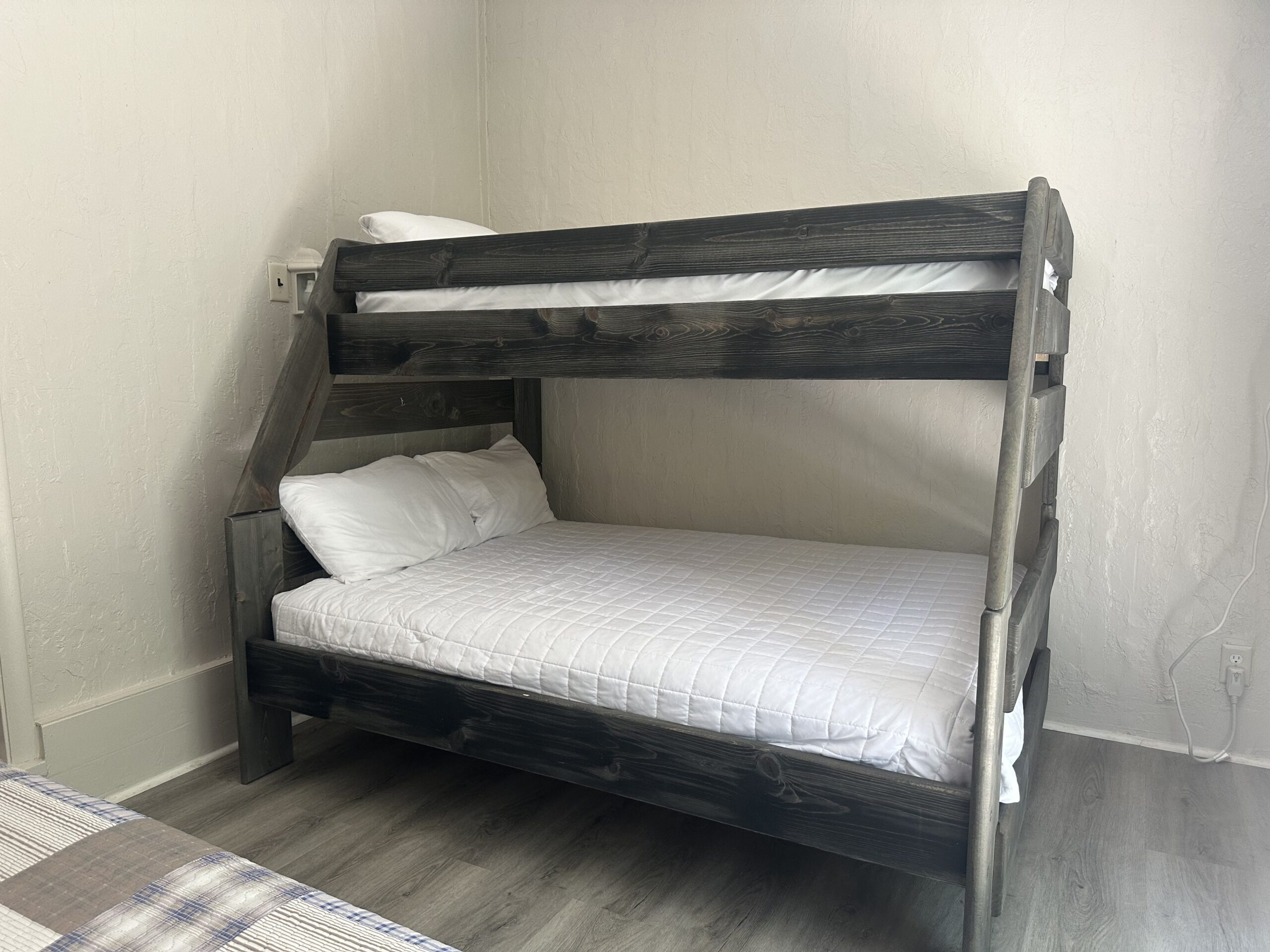 a bunk bed in a room with white walls
