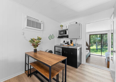 a kitchen with a table and a microwave