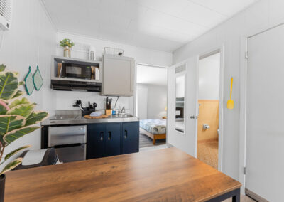 a kitchen with a wooden table and a microwave