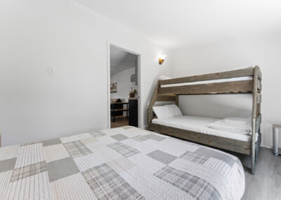 a bedroom with a bed and a bunk bed