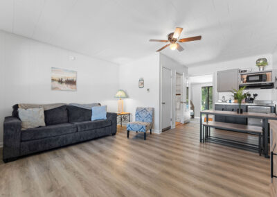 a living room filled with furniture and a ceiling fan