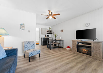 a living room filled with furniture and a flat screen tv