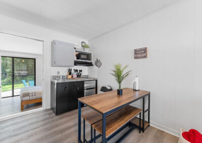a kitchen with a table and a refrigerator