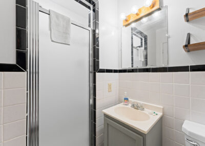 a bathroom with a sink, mirror, and toilet