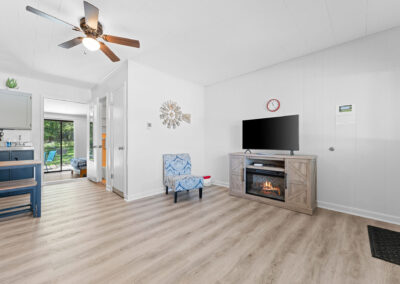 a living room with hardwood floors and a ceiling fan
