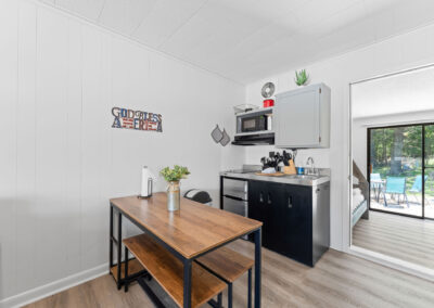 a kitchen and living room with a sliding glass door