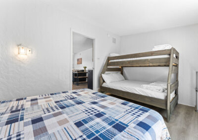 a bedroom with a bunk bed and a desk
