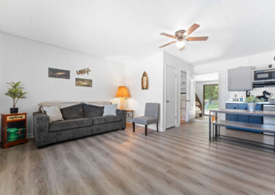 a living room filled with furniture and a kitchen