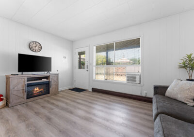 a living room with a gray couch and a flat screen tv