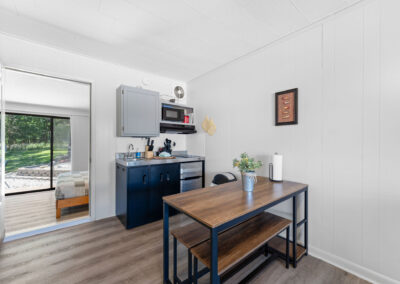 a kitchen with a table and a microwave