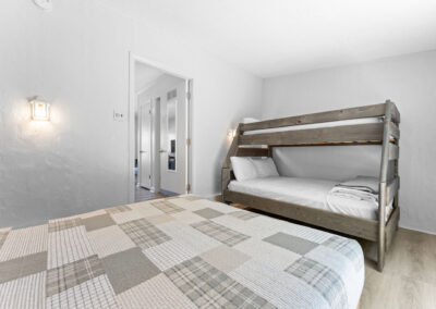 a bedroom with a bed and a bunk bed