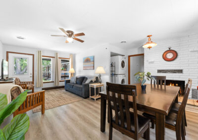 a living room and dining room with a fireplace