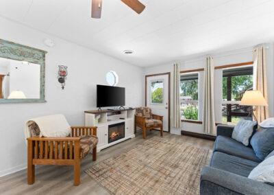 a living room filled with furniture and a flat screen tv