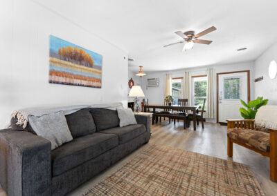 a living room filled with furniture and a ceiling fan