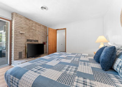 a bedroom with a large bed and a flat screen tv