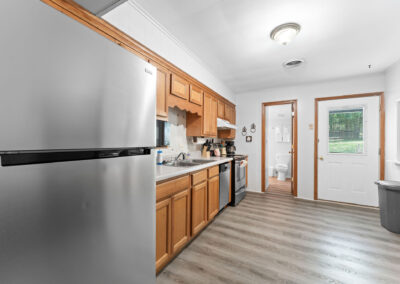 a kitchen with stainless steel appliances and wood cabinets