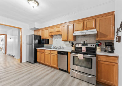a kitchen with wooden cabinets and stainless steel appliances