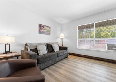a living room filled with furniture and a window