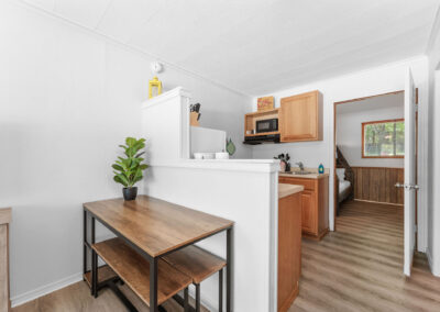 a kitchen with a wooden table and a microwave