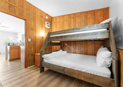 a bunk bed in a room with wood paneling