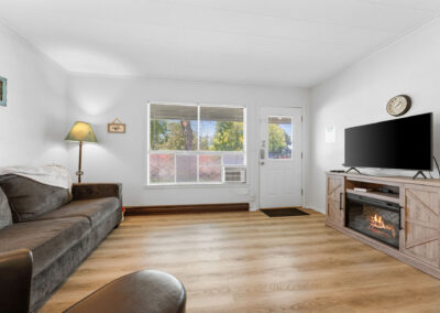 a living room filled with furniture and a flat screen tv