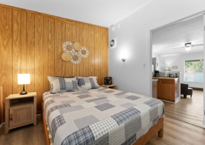 a bedroom with wood paneling and a bed