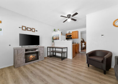 a living room filled with furniture and a flat screen tv