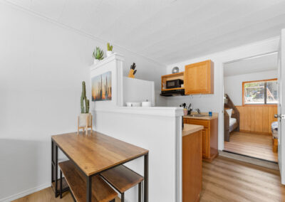 a kitchen with a wooden table and a microwave