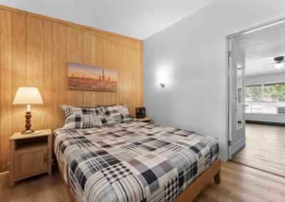 a bed sitting in a bedroom next to a doorway