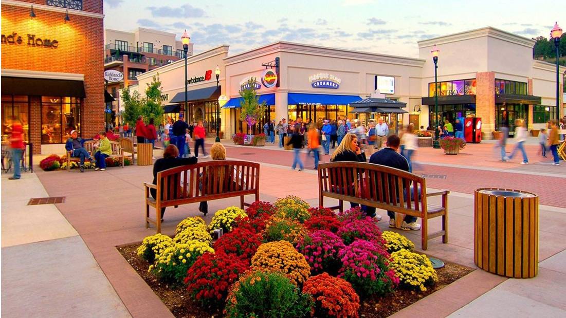 BransonLanding-Shopping_CO-Brans a group of people walking around a shopping center